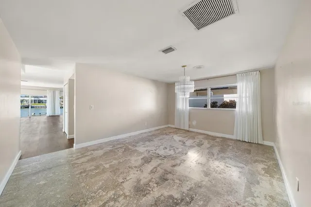 a view of a room with wooden floor and ceiling fan