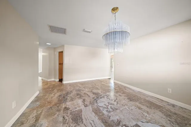 a spacious bathroom with a granite countertop sink a toilet a mirror and shower