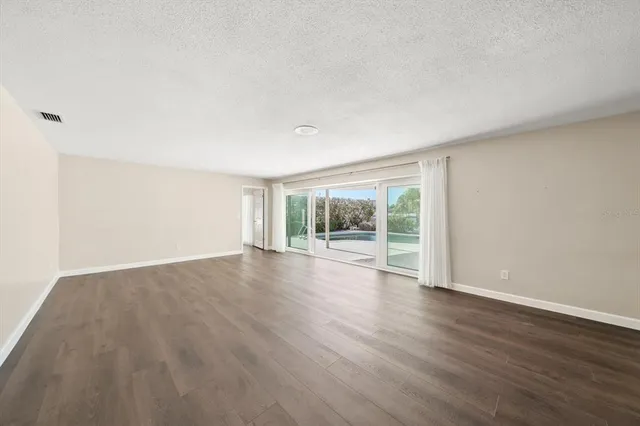 a bathroom with a granite countertop toilet sink and mirror