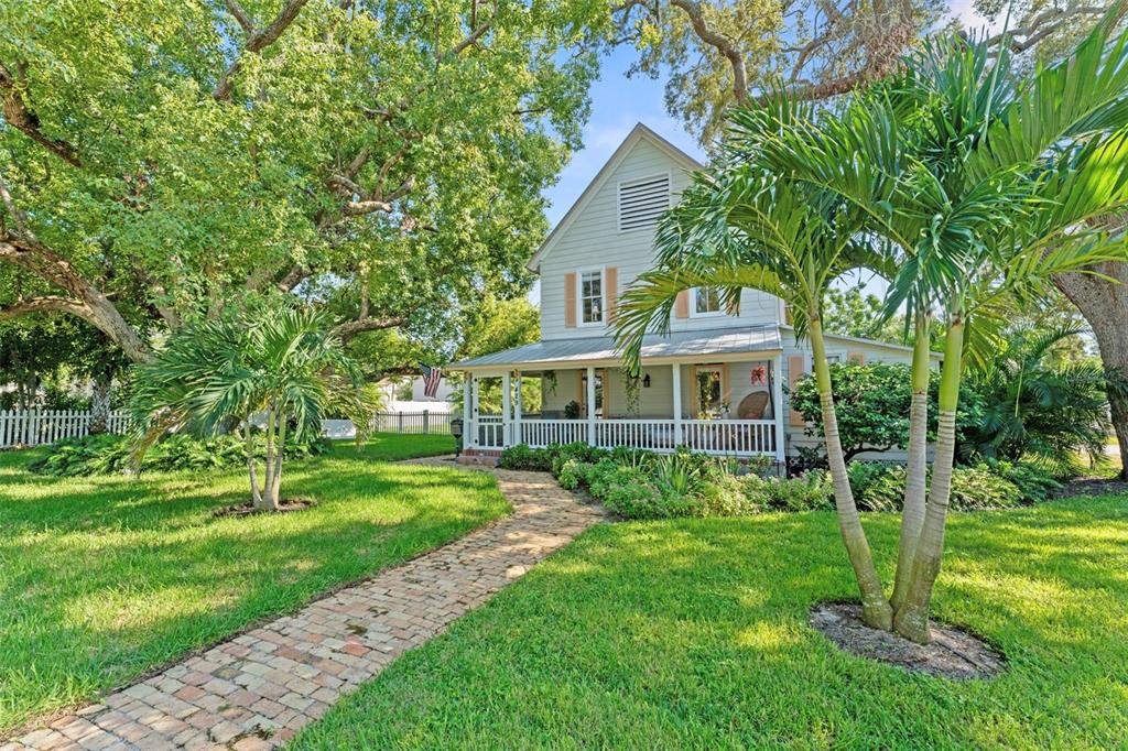 429 Scotland Street Dunedin, FL 34698 - Photo 2 of 78 a front view of a house with a yard