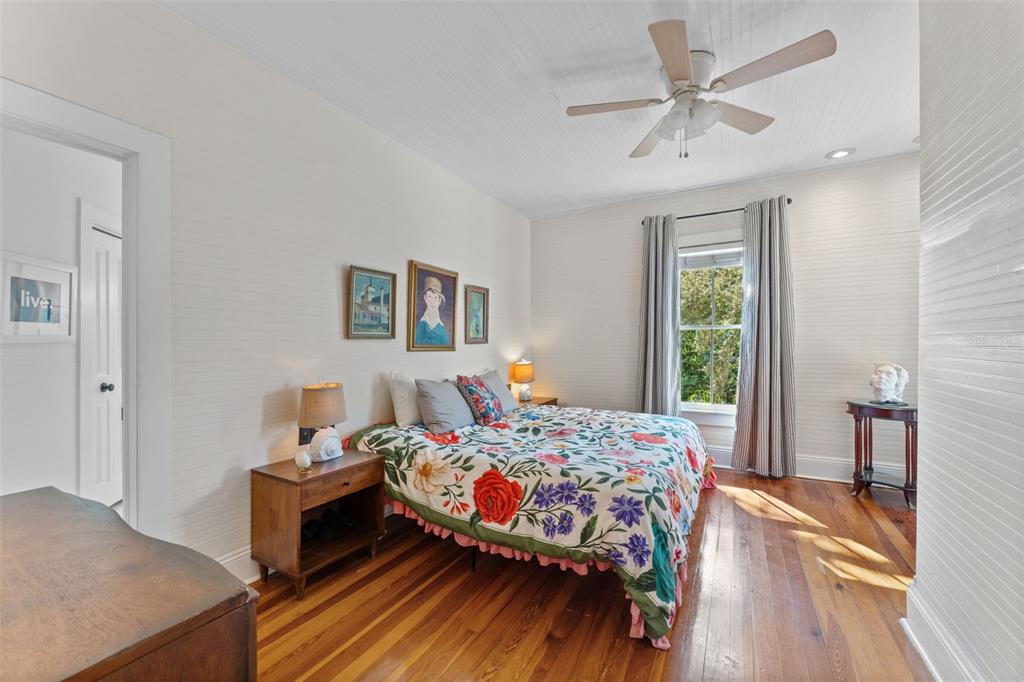 429 Scotland Street Dunedin, FL 34698 - Photo 32 of 78 a bedroom with a bed and a chandelier