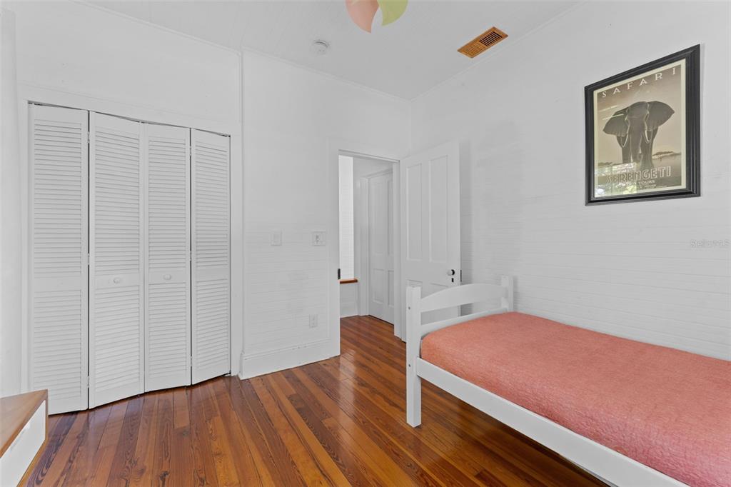 429 Scotland Street Dunedin, FL 34698 - Photo 45 of 78 a bedroom with a bed and wooden floor