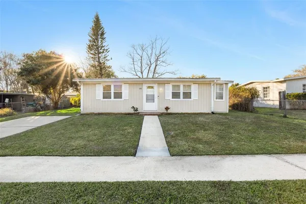 a view of house with a yard