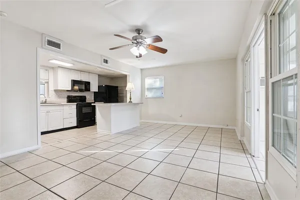 a view of a kitchen with microwave and cabinets