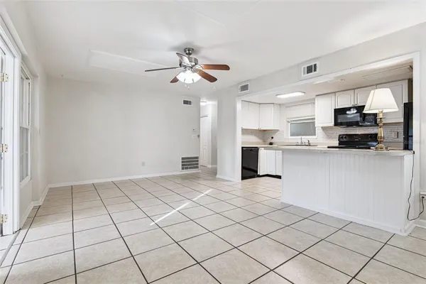a view of kitchen with microwave and cabinets