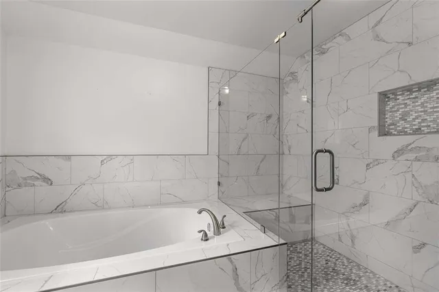 a bathroom with a bath tub and shower