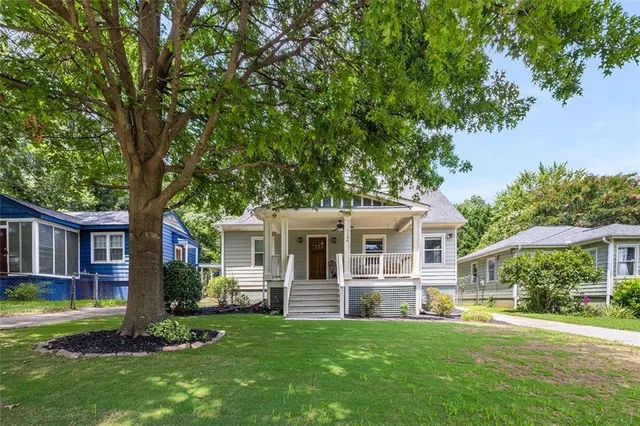 a front view of house with yard and green space