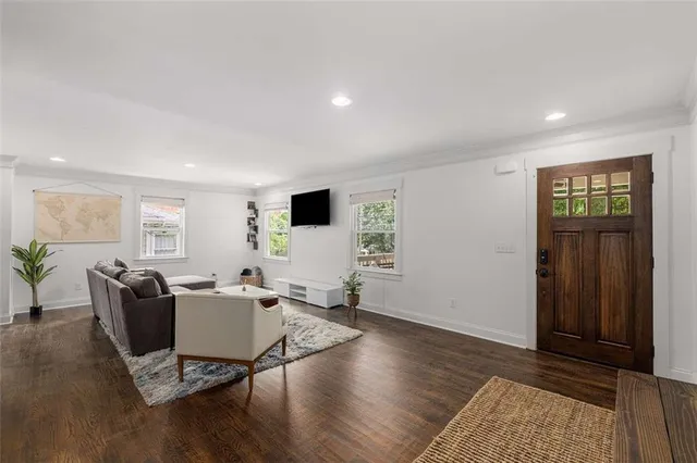 a living room with furniture and wooden floor