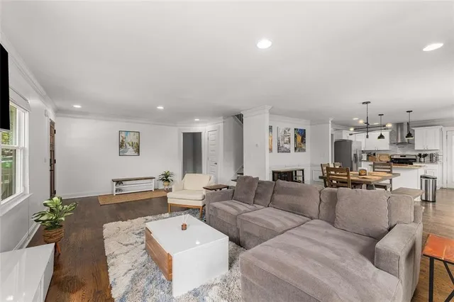 a living room with furniture and wooden floor