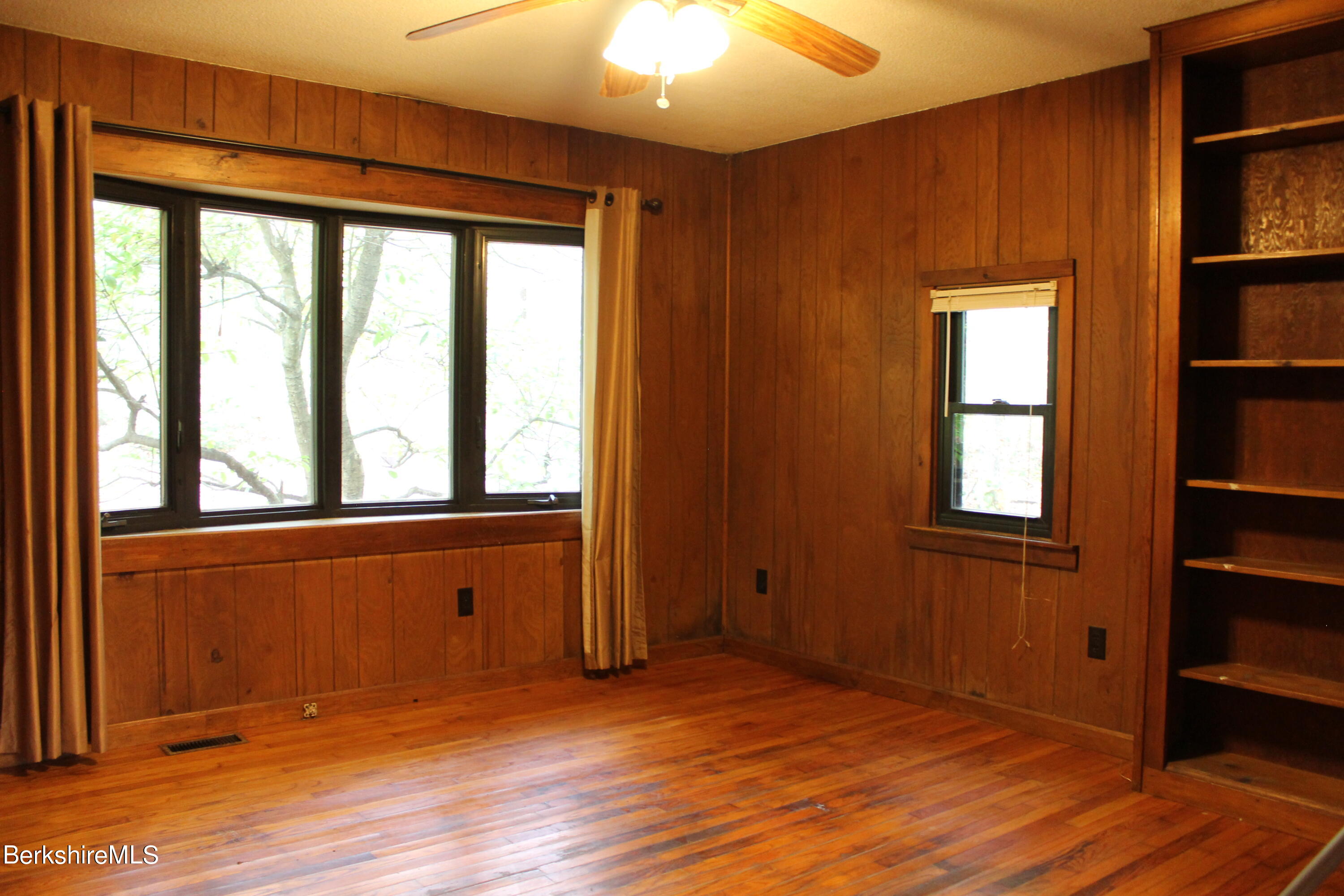 46 East Windsor Road Peru, MA 01235 - Photo 12 of 29 an empty room with wooden floor and windows