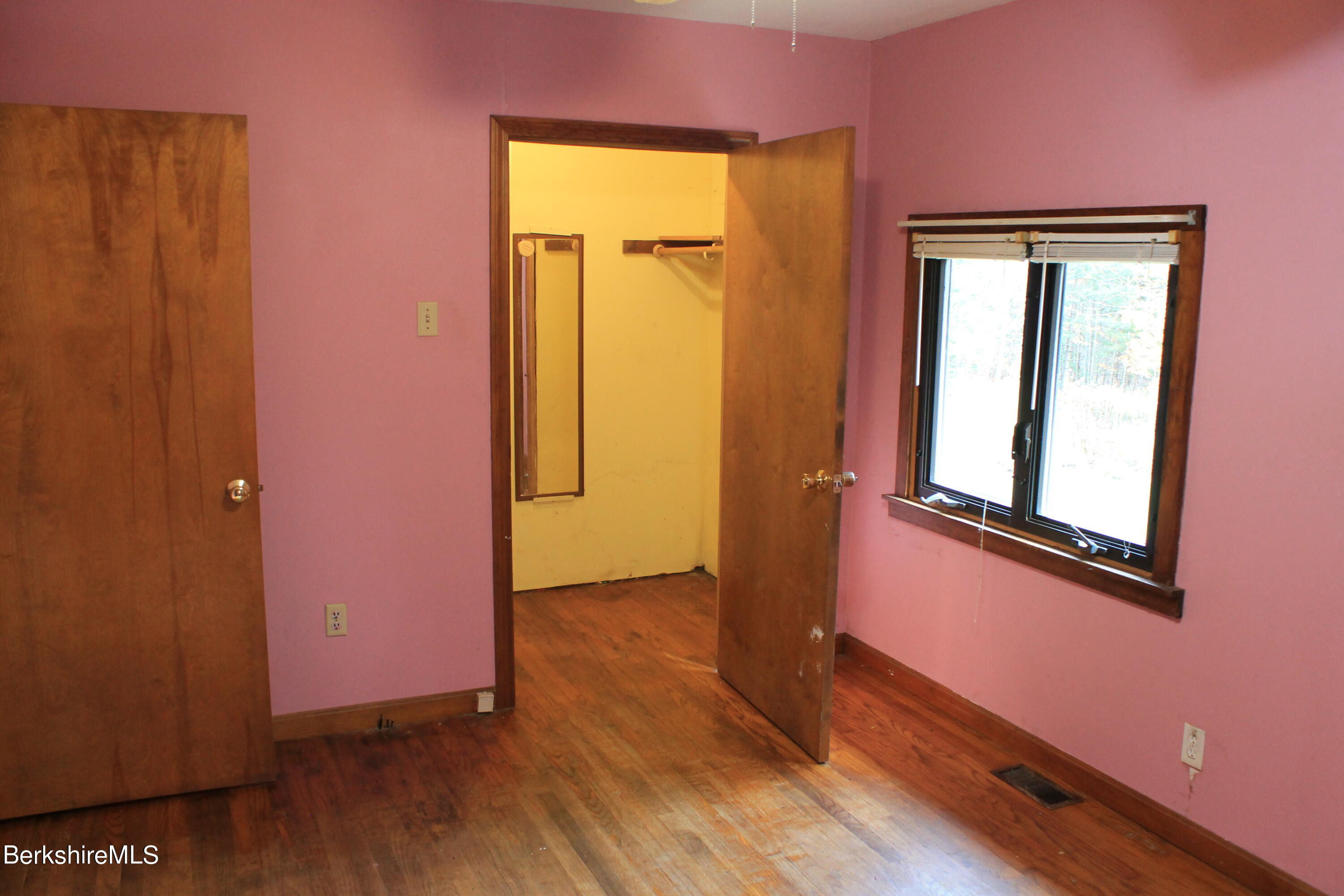 46 East Windsor Road Peru, MA 01235 - Photo 18 of 29 an empty room with wooden floor and a window