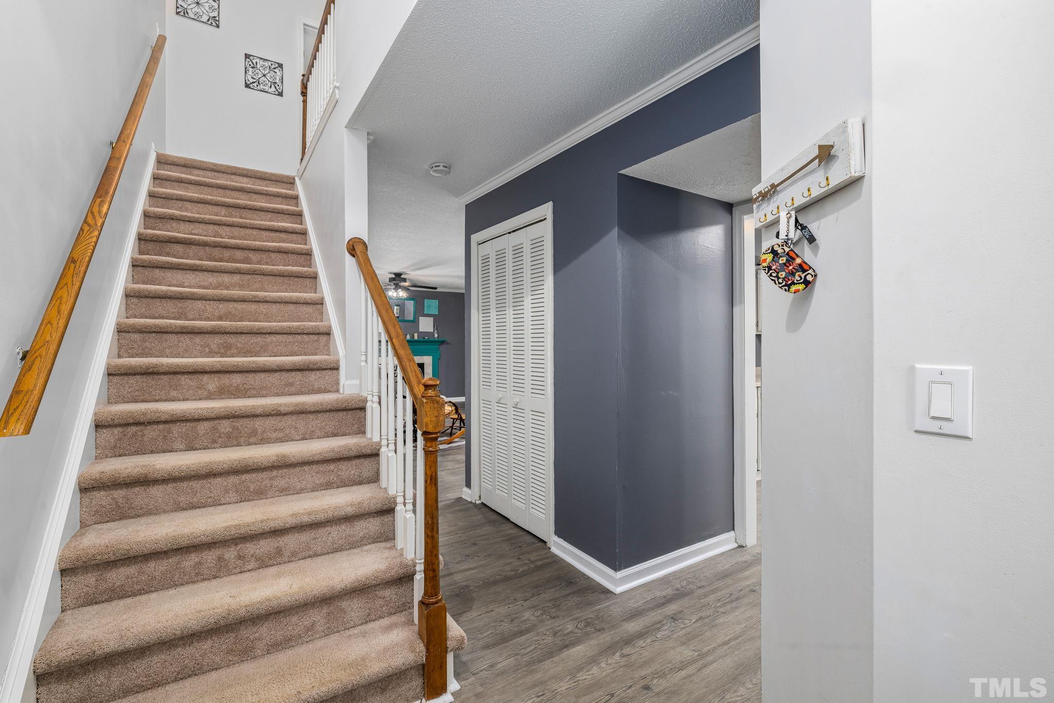 302 Broad Leaf Circle, Unit 302 Raleigh, NC 27613 - Photo 3 of 13 a view of entryway with stairs and wooden floor