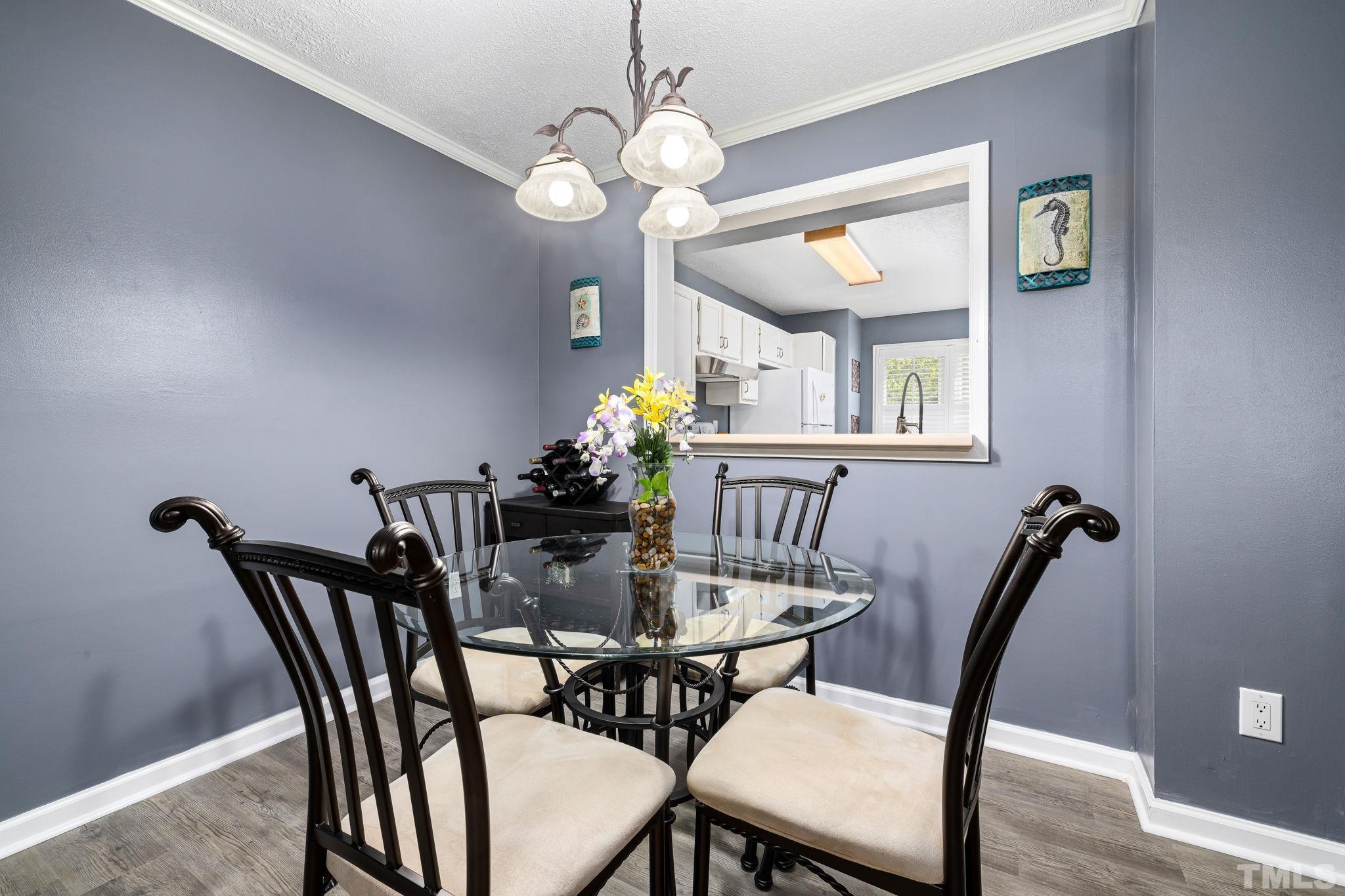302 Broad Leaf Circle, Unit 302 Raleigh, NC 27613 - Photo 6 of 13 a view of a dining room with furniture and chandelier