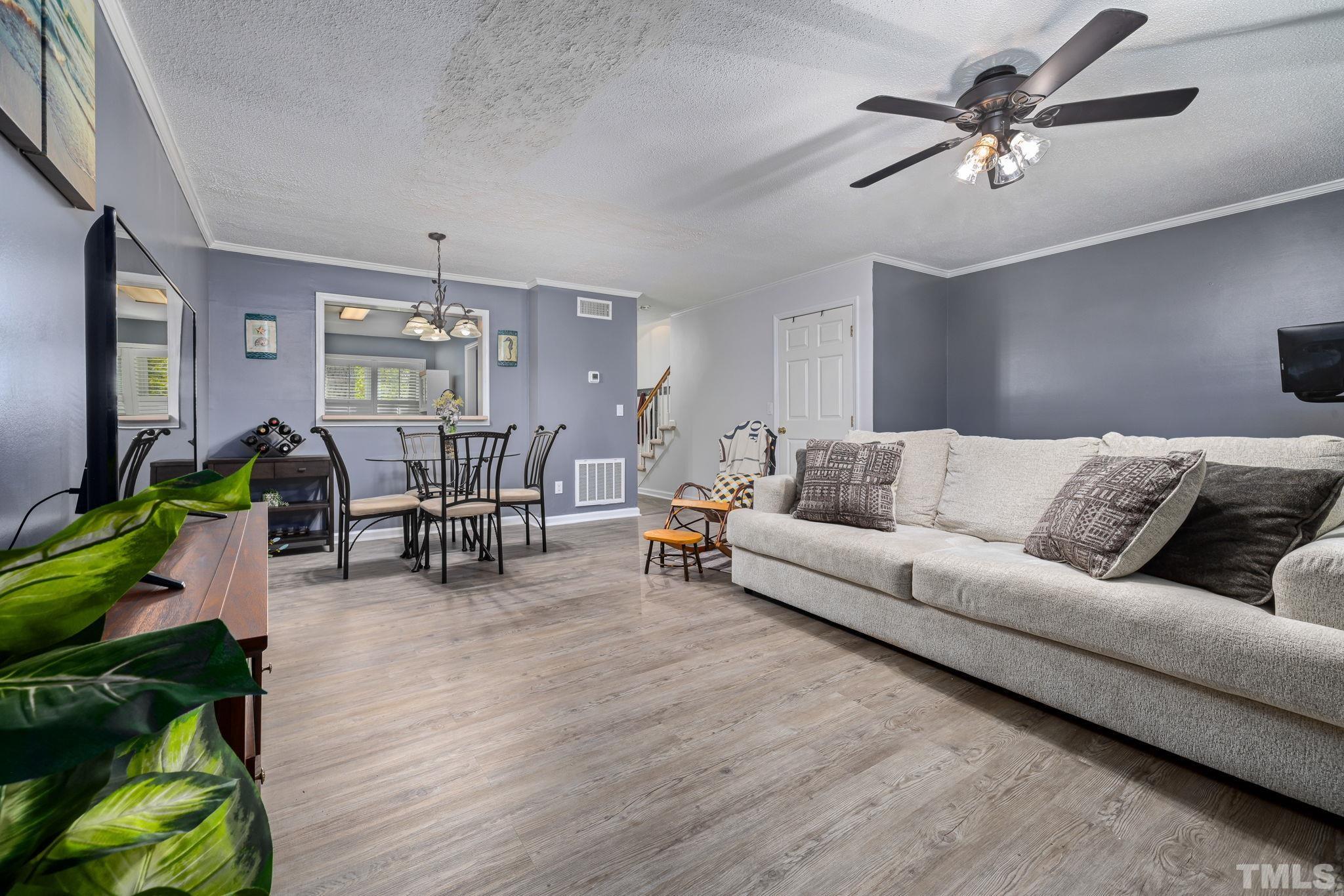 302 Broad Leaf Circle, Unit 302 Raleigh, NC 27613 - Photo 7 of 13 a living room with furniture and wooden floor