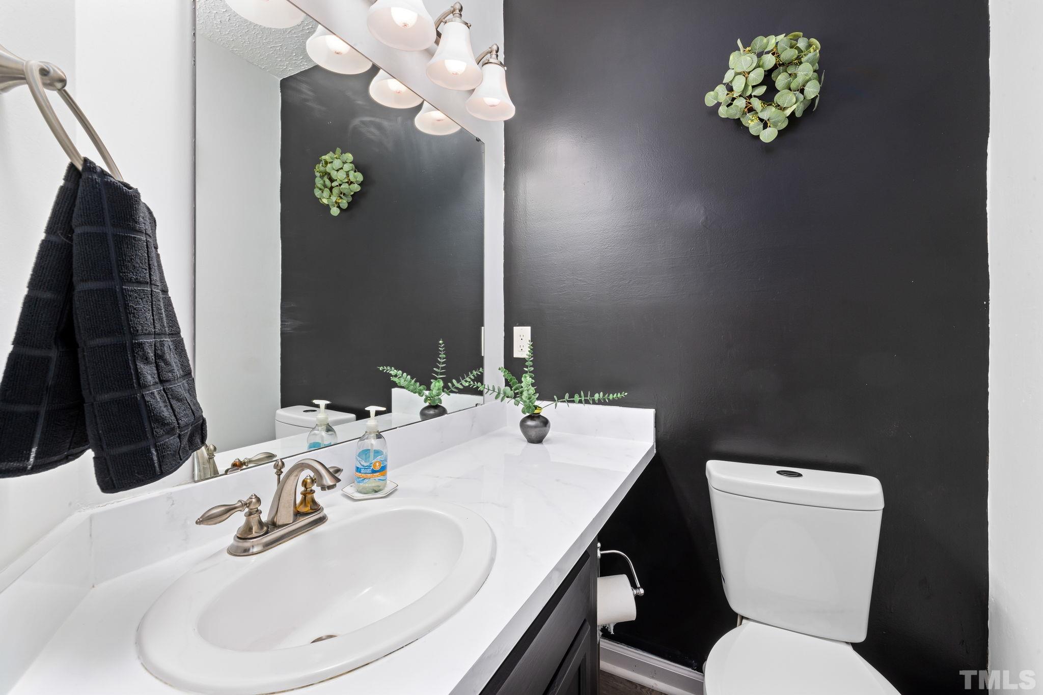 302 Broad Leaf Circle, Unit 302 Raleigh, NC 27613 - Photo 8 of 13 a bathroom with a sink a toilet and a mirror