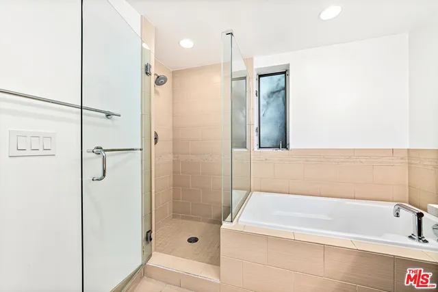 a bathroom with a bathtub and a shower