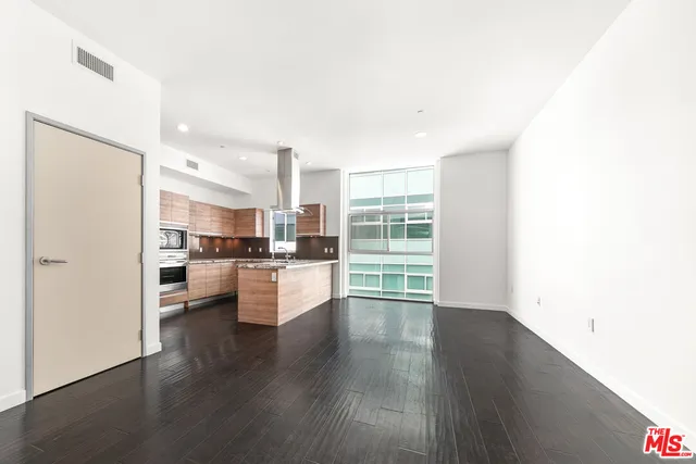 a view of kitchen with wooden floor and electronic appliances