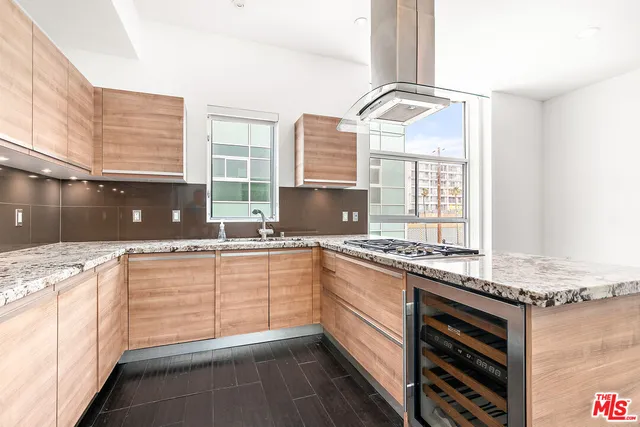 a kitchen with granite countertop a sink and a stove