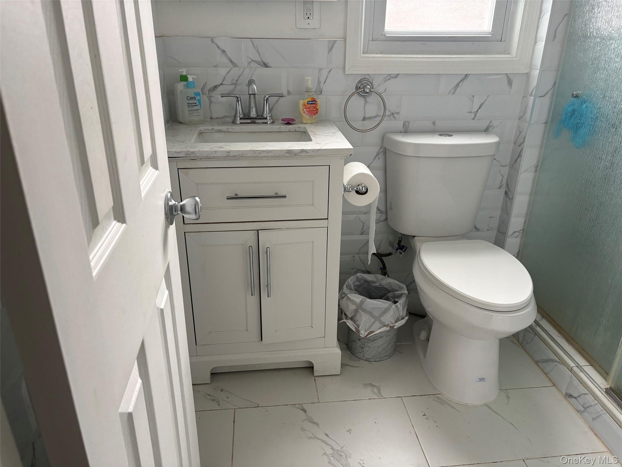 91 Broadway Valley Stream, NY 11580 - Photo 11 of 12 a bathroom with a toilet sink and mirror