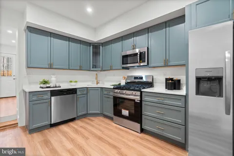 a kitchen with granite countertop stainless steel appliances and cabinets