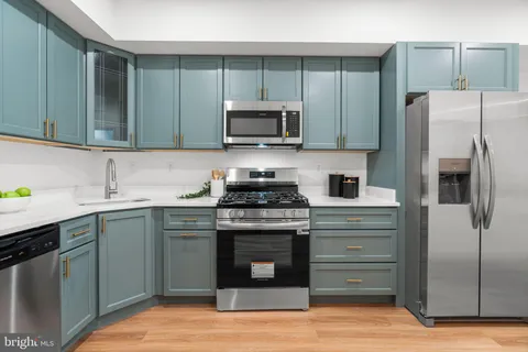 a kitchen with a sink and a stove top oven