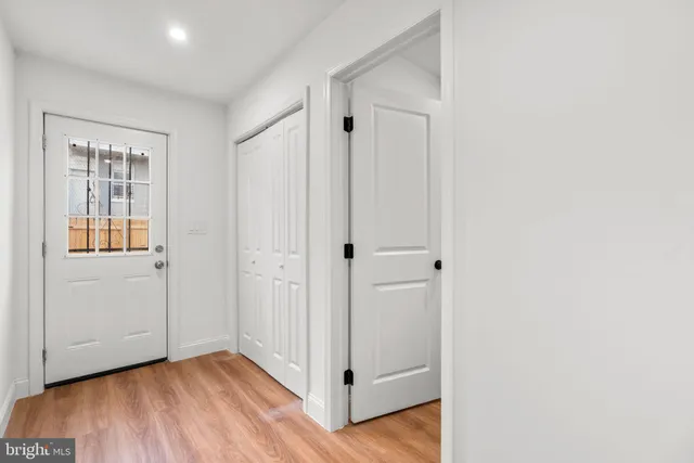 a view of a hallway with wooden floor