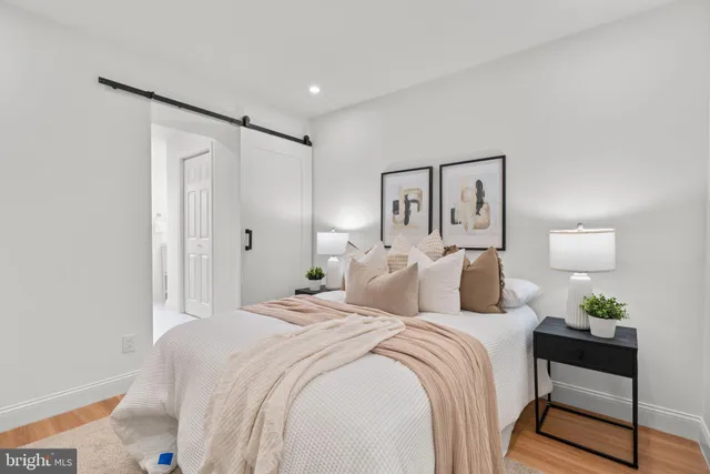 a bedroom with a bed and a lamp