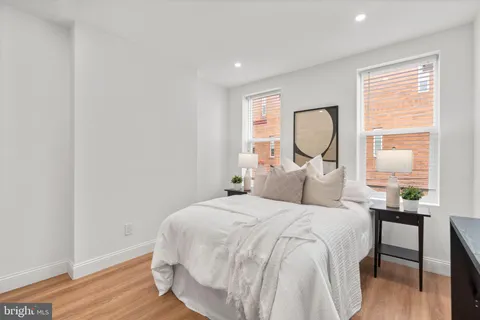 a bedroom with a bed and a painting on the wall