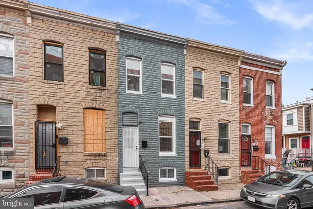 a front view of a house with parking space