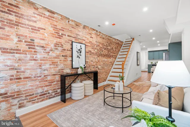 a living room with furniture and stairs