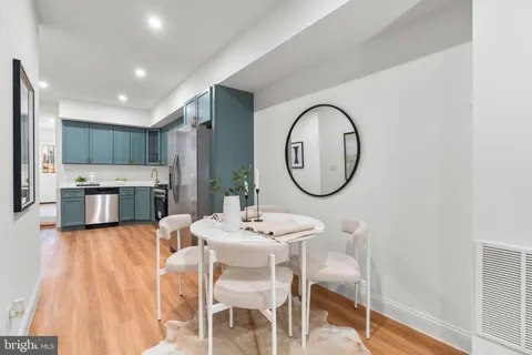 a dining room with kitchen island a table and chairs