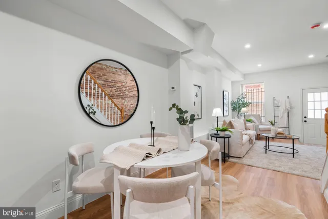 a living room with furniture a clock and a table
