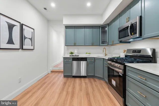 a kitchen with stainless steel appliances granite countertop a stove and a sink