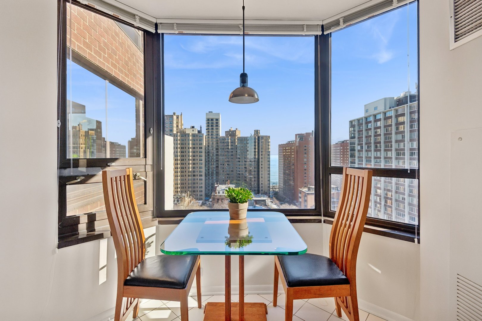 1410 North State Parkway, Unit 18B Chicago, IL 60610 - Photo 16 of 31 a view of a dining room with furniture window and wooden floor