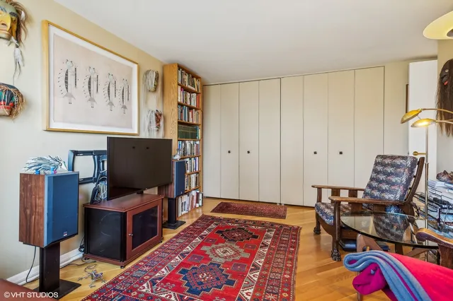 a view of a workspace with furniture and wooden floor