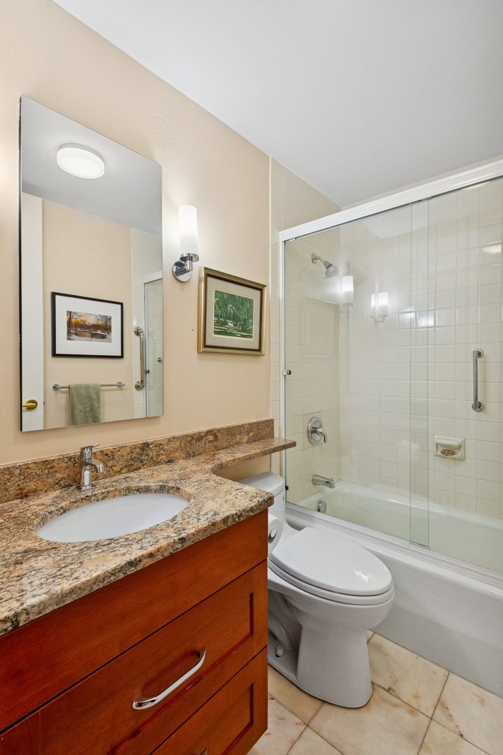 1410 North State Parkway, Unit 18B Chicago, IL 60610 - Photo 26 of 31 a bathroom with a granite countertop sink a toilet a mirror and shower