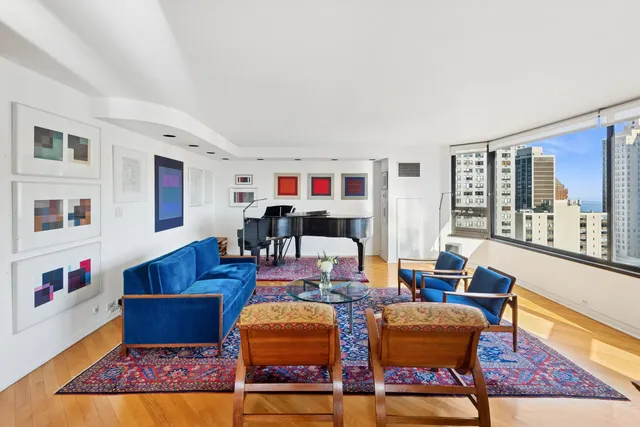 a living room with furniture fireplace and rug floor