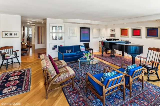 a living room with furniture a rug and a window