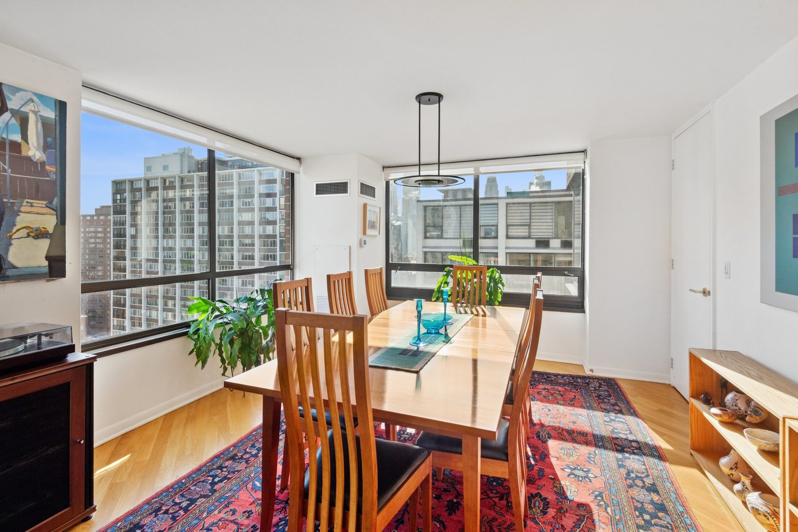 1410 North State Parkway, Unit 18B Chicago, IL 60610 - Photo 9 of 31 a dining room with furniture a chandelier and wooden floor