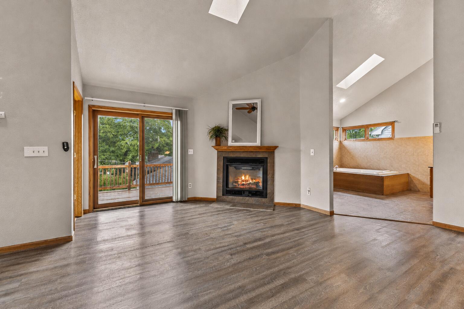 2925 North Main Street Racine, WI 53402 - Photo 9 of 23 Relax by the cozy fireplace, step directly onto the expansive upper deck, or unwind in your private spa-inspired ensuite—all from this exceptional owner's retreat.