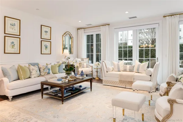 a living room with furniture and large windows