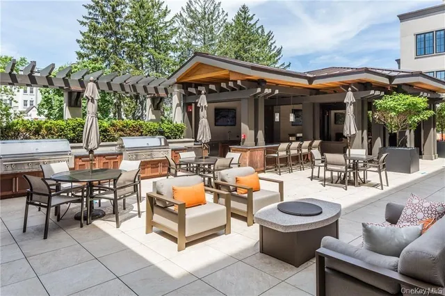 a view of a patio with dining table and chairs and potted plants