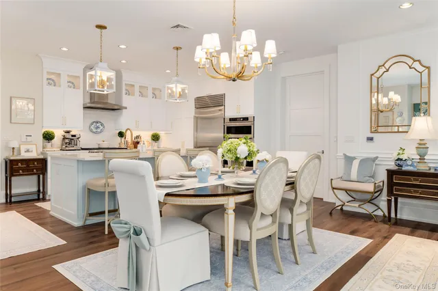 a view of a dining room with furniture and chandelier