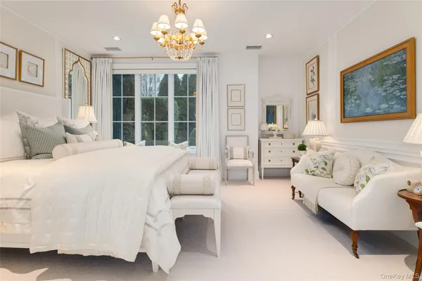 a spacious bedroom with a bed and a couch