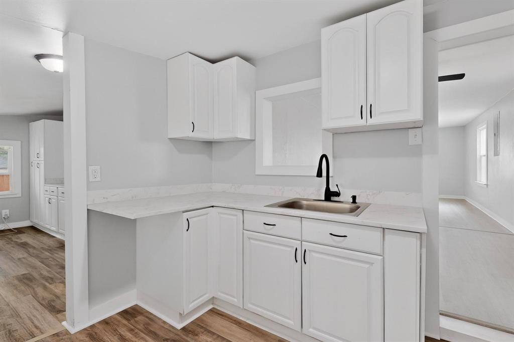 313 Farm To Market 316 Eustace, TX 75124 - Photo 14 of 33 a kitchen with white cabinets and sink