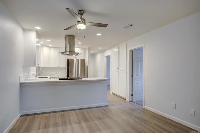 a view of kitchen with cabinets and wooden floor