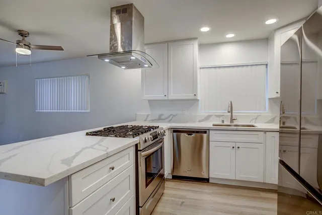 a kitchen with a stove a sink and a refrigerator