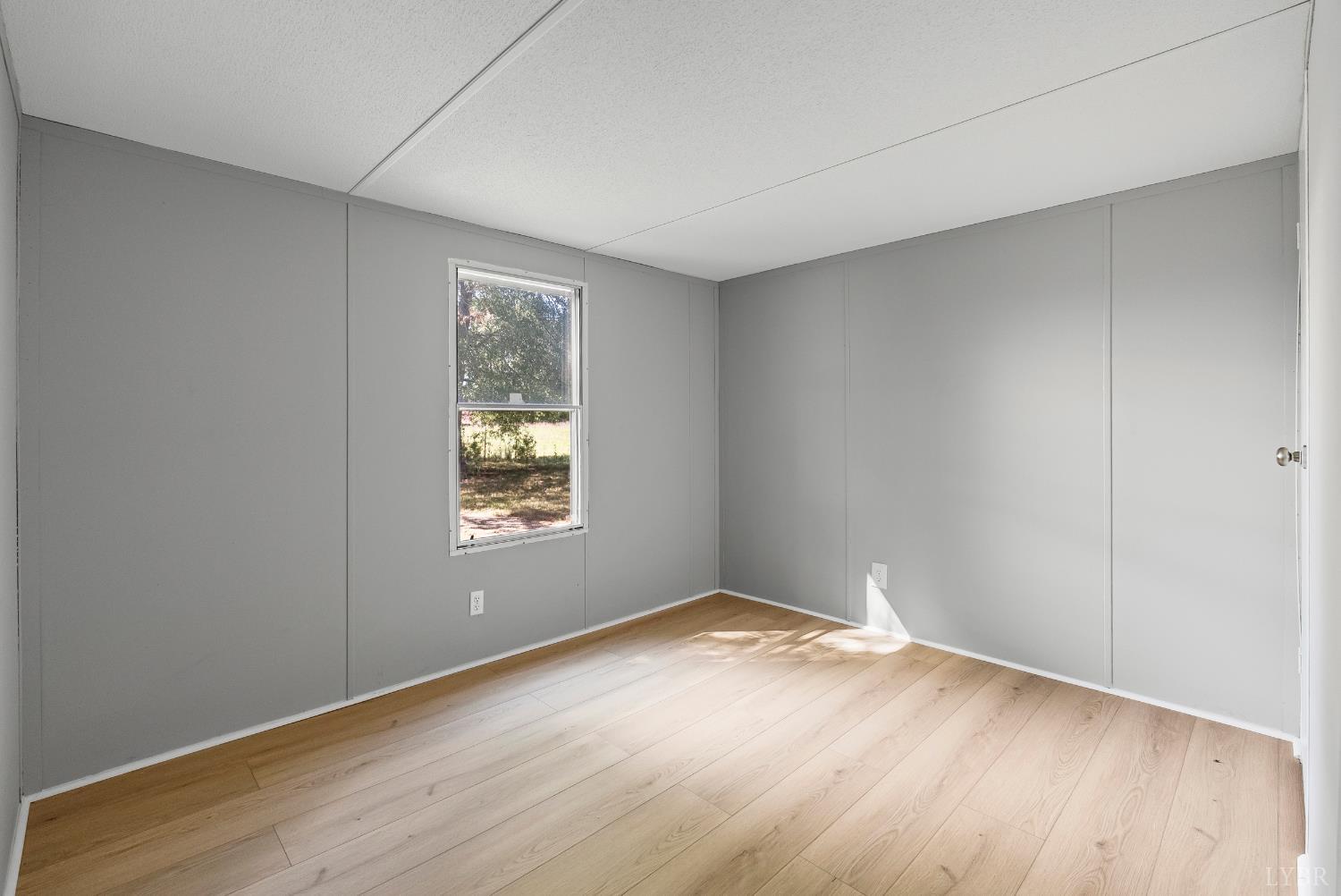 2141 Gap Road Chatham, VA 24531 - Photo 23 of 39 an empty room with wooden floor and windows