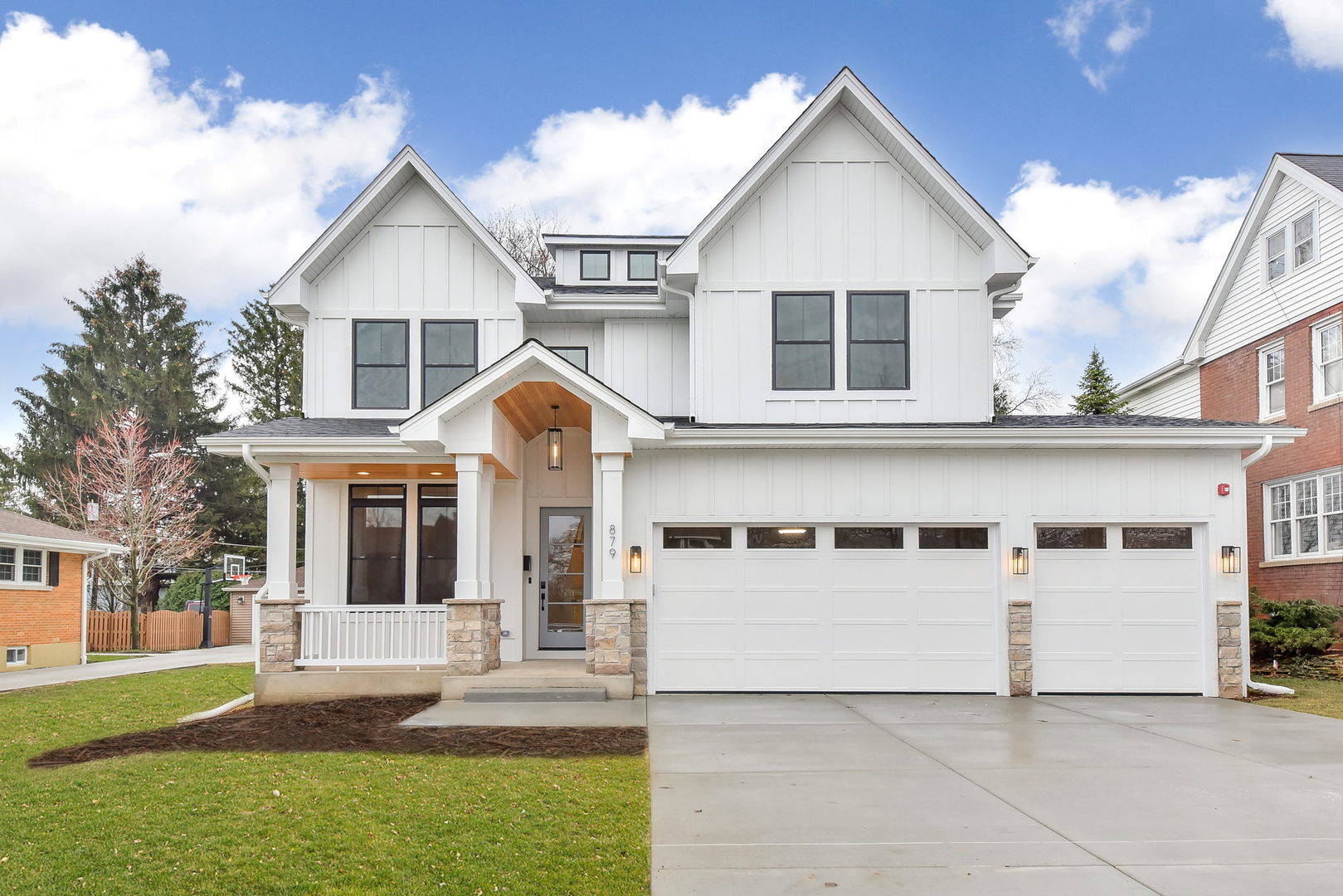 a view of white house with a yard and large tree