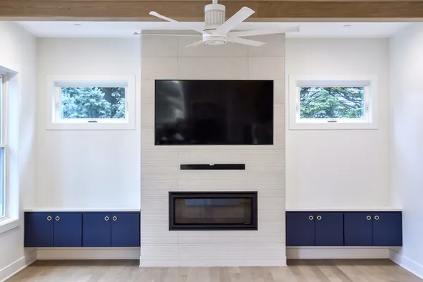 a living room with a fireplace and a flat screen tv